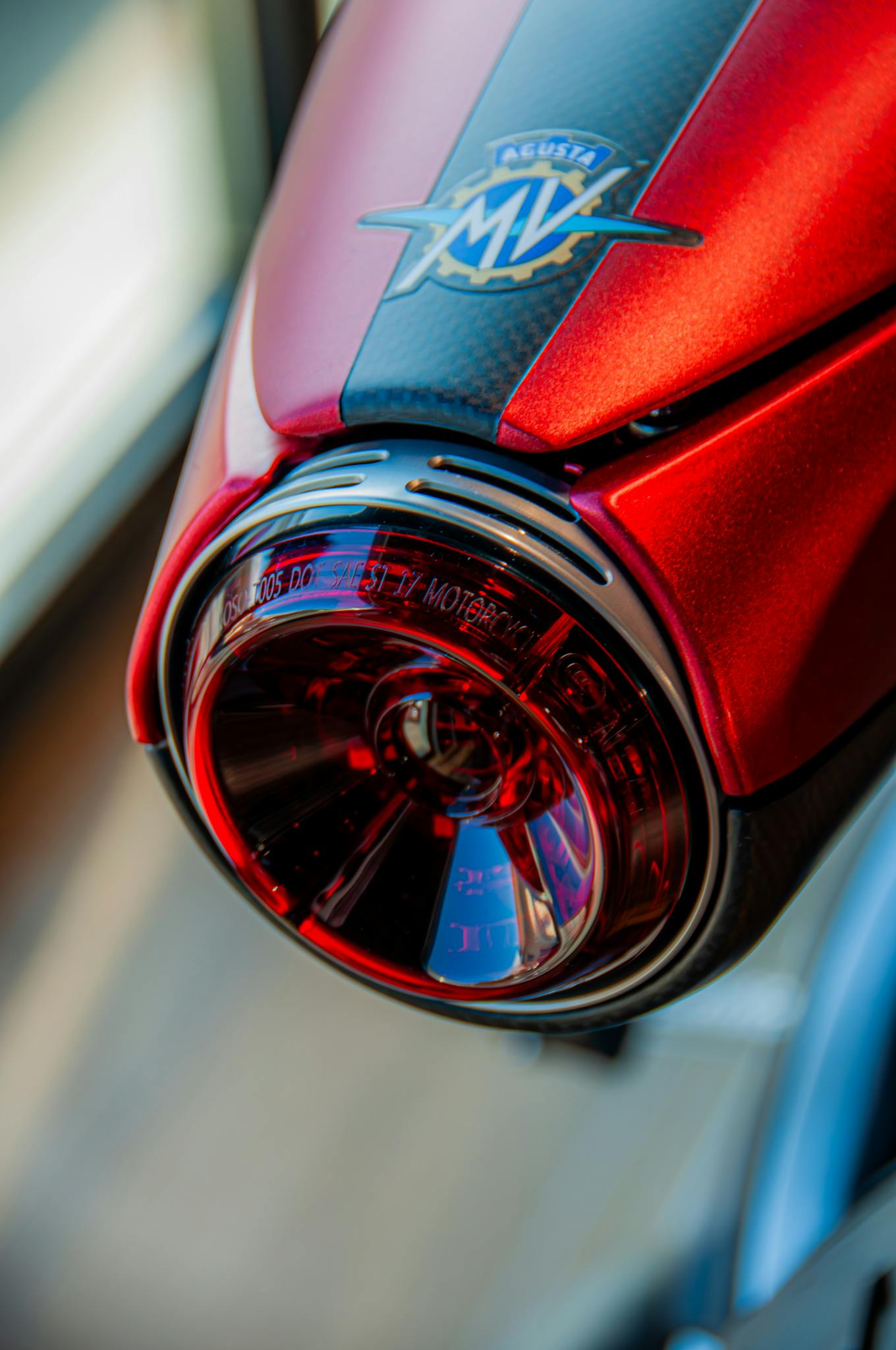 Detailed vertical shot of an MV Agusta motorcycle's red taillight showcasing modern design.
